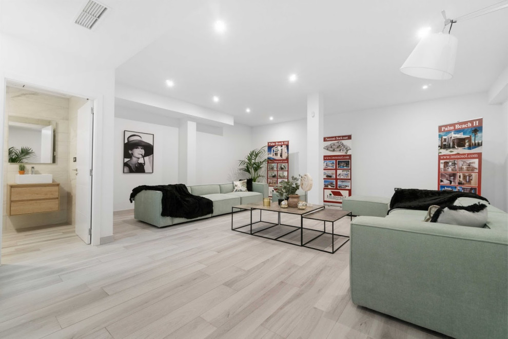 Photo of a mid-sized contemporary basement in Other with white walls, ceramic floors and beige floor.