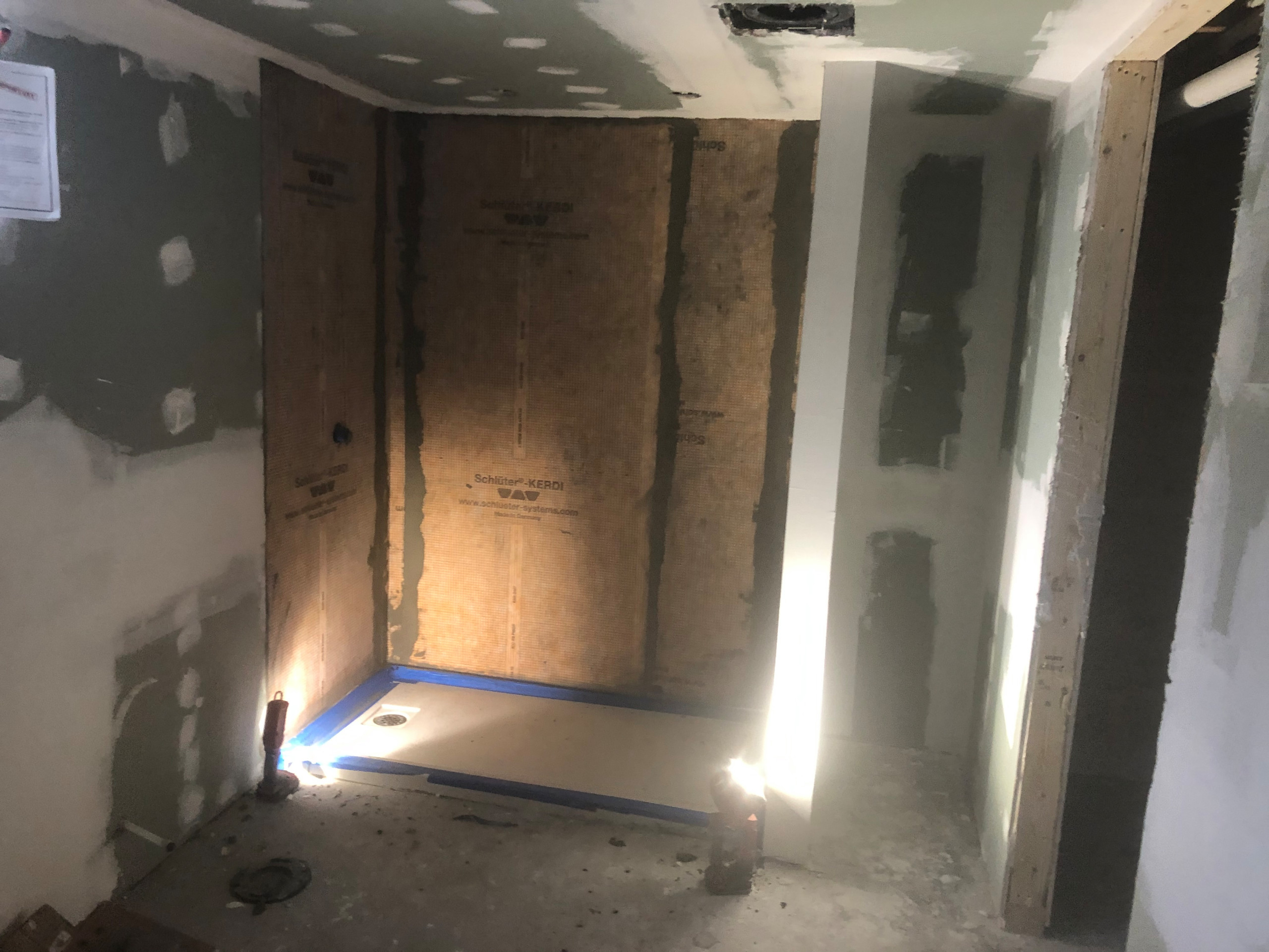 Tile install process including under tile waterproofing