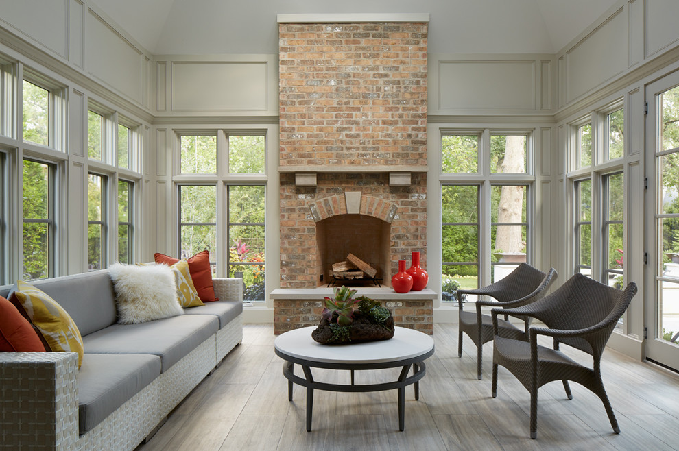 Design ideas for a traditional sunroom in Chicago with a standard fireplace and a brick fireplace surround.