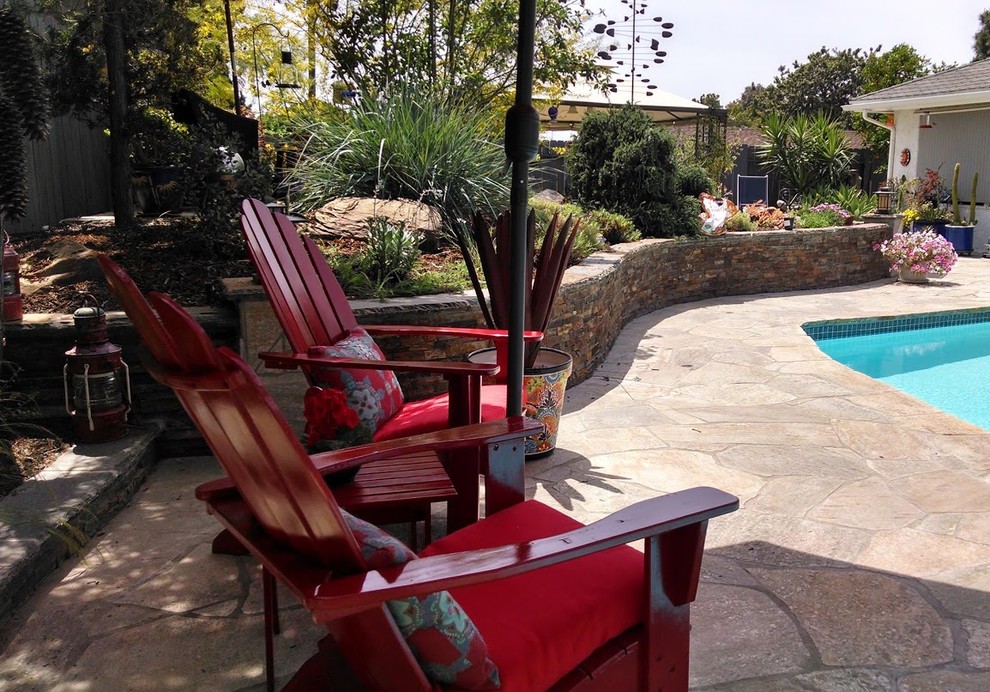 Pool - mid-sized rustic backyard rectangular and stone lap pool idea in Orange County