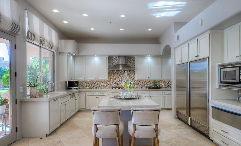 Large u-shaped travertine floor open concept kitchen photo in Phoenix with an undermount sink, shaker cabinets, quartzite countertops, multicolored backsplash, mosaic tile backsplash, stainless steel appliances and an island