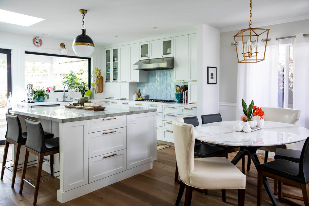 This is an example of a mid-sized transitional u-shaped open plan kitchen in San Francisco with an undermount sink, shaker cabinets, white cabinets, quartzite benchtops, blue splashback, ceramic splashback, medium hardwood floors, with island and green benchtop.