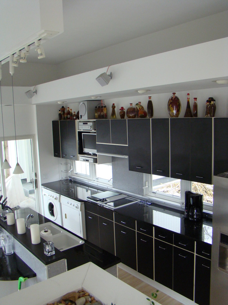 Enclosed kitchen - galley enclosed kitchen idea in St Louis with a drop-in sink, flat-panel cabinets, white cabinets and no island