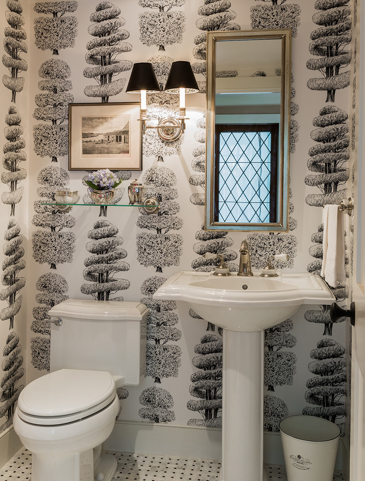 This is an example of a traditional powder room in Boston with a pedestal sink and multi-coloured walls.