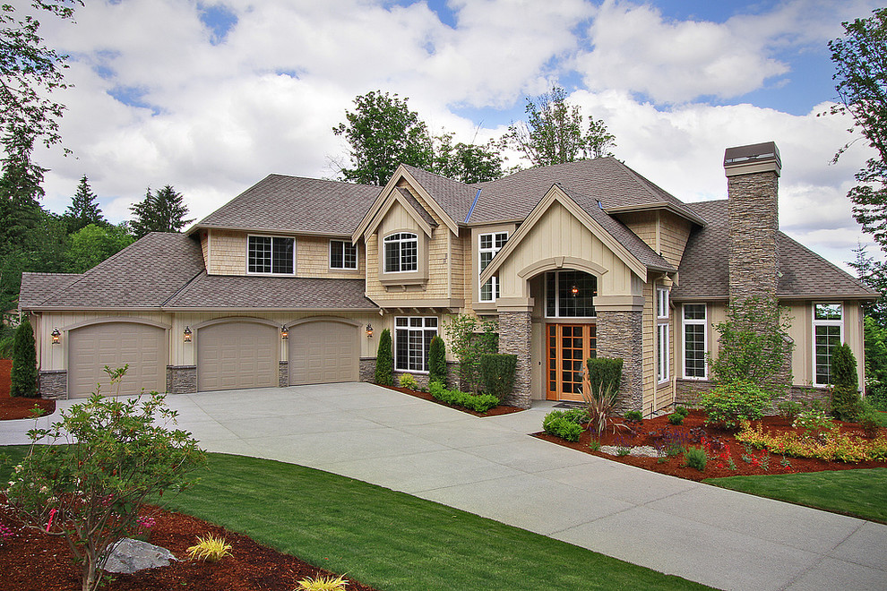 Photo of a large traditional two-storey beige house exterior in Seattle with wood siding, a gable roof and a shingle roof.