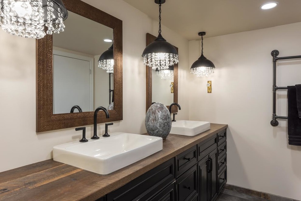 Large country master bathroom in St Louis with recessed-panel cabinets, black cabinets, white walls, painted wood floors, a vessel sink, wood benchtops, brown floor and brown benchtops.