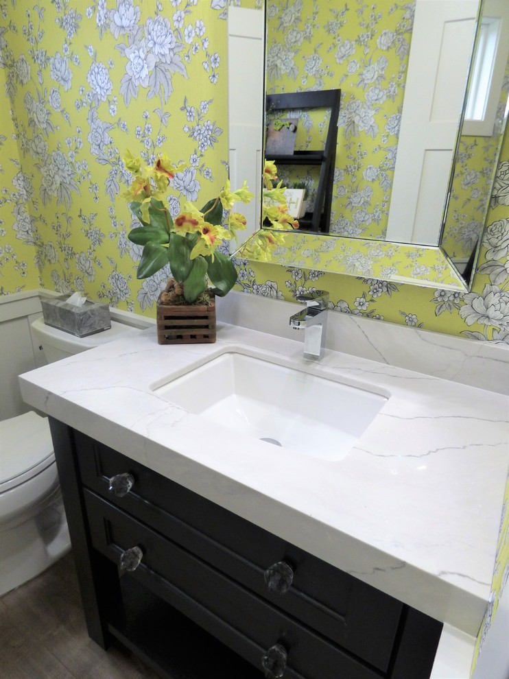 Small transitional 3/4 bathroom in Other with recessed-panel cabinets, grey cabinets, brown floor, a two-piece toilet, yellow tile, yellow walls, medium hardwood floors, an undermount sink and engineered quartz benchtops.