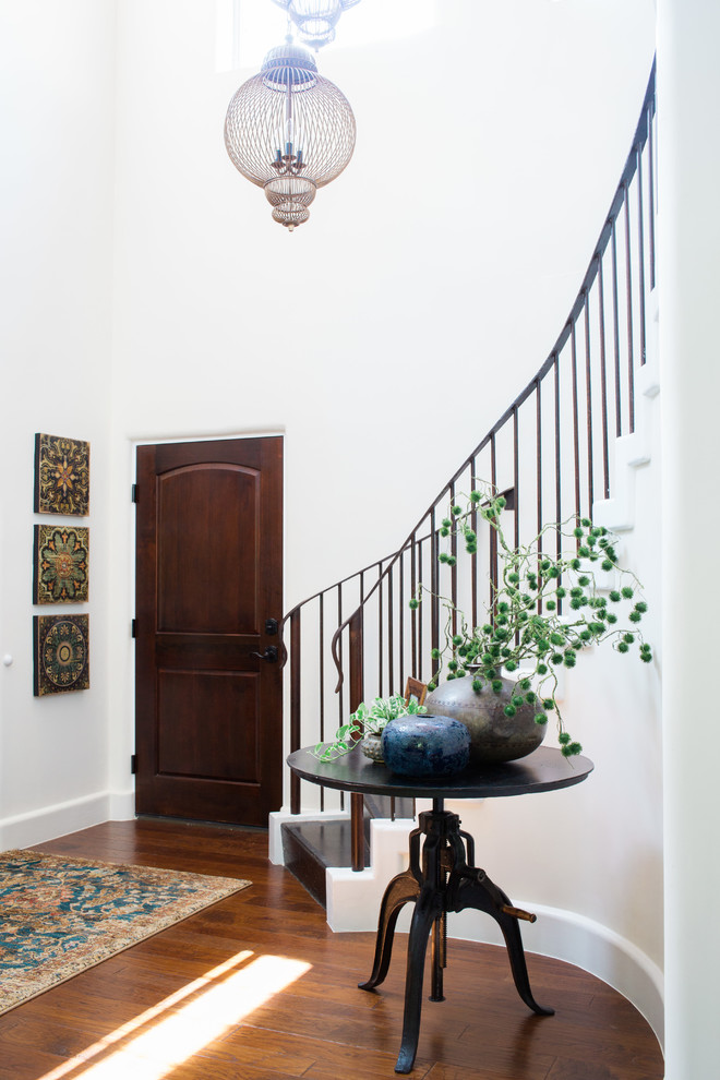 Inspiration for a large mediterranean wood curved staircase in Austin with wood risers and metal railing.