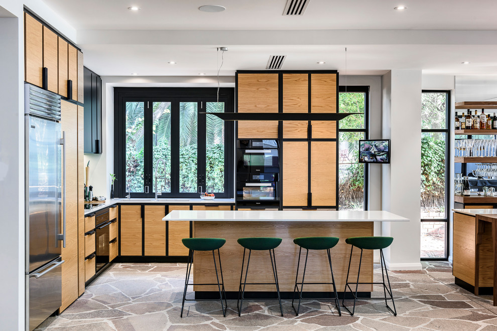Design ideas for a contemporary l-shaped open plan kitchen in Adelaide with flat-panel cabinets, medium wood cabinets, black appliances, multiple islands and grey floor.