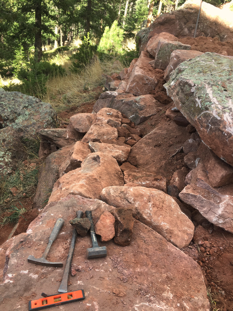 Design ideas for a huge rustic hillside retaining wall landscape in Denver.