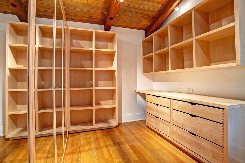 Photo of a contemporary storage and wardrobe in San Diego with open cabinets and light wood cabinets.