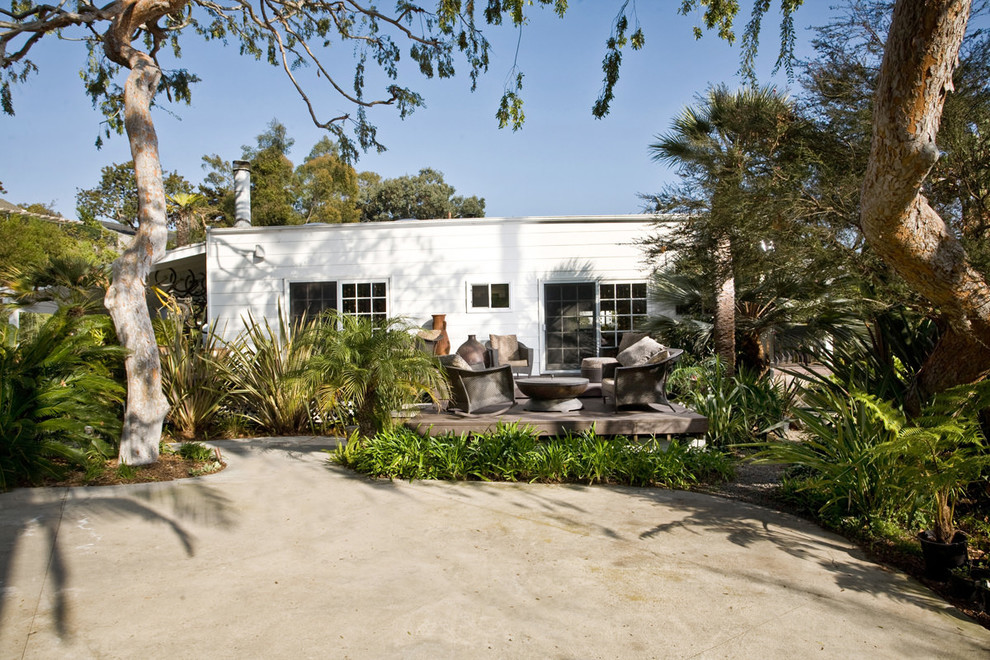 Patio kitchen - large tropical backyard concrete patio kitchen idea in San Diego with a roof extension