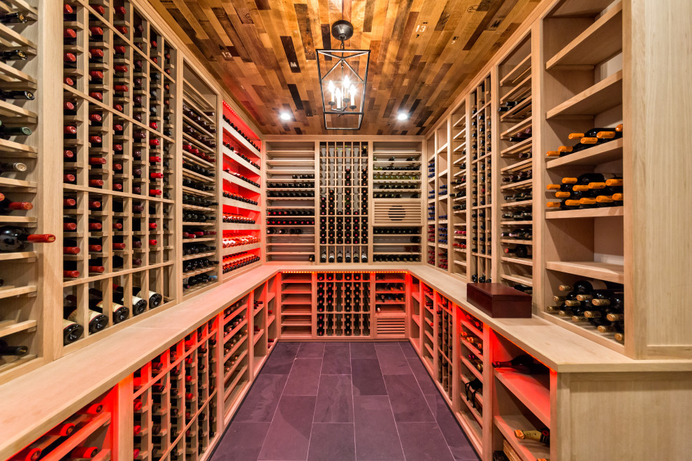 Inspiration for a mid-sized country wine cellar in New York with slate floors, storage racks and black floor.