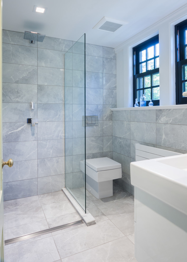 Small modern master bathroom in Boston with flat-panel cabinets, white cabinets, an open shower, gray tile, ceramic tile, grey walls, ceramic floors, an integrated sink, a one-piece toilet, solid surface benchtops, grey floor and an open shower.