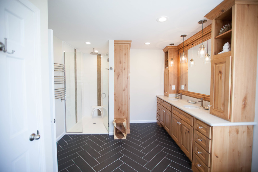 Design ideas for a mid-sized eclectic master bathroom in St Louis with raised-panel cabinets, medium wood cabinets, an alcove shower, a one-piece toilet, white tile, subway tile, white walls, porcelain floors, an undermount sink and engineered quartz benchtops.