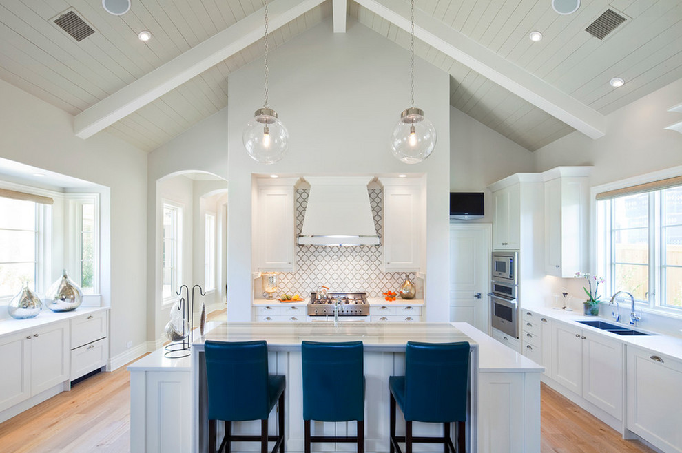 Example of a huge transitional u-shaped light wood floor kitchen design in Detroit with a double-bowl sink, shaker cabinets, white cabinets, gray backsplash, stainless steel appliances and an island