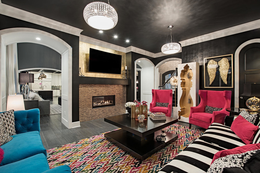 This is an example of an expansive transitional enclosed living room in Cleveland with black walls, dark hardwood floors, a standard fireplace, a tile fireplace surround and grey floor.