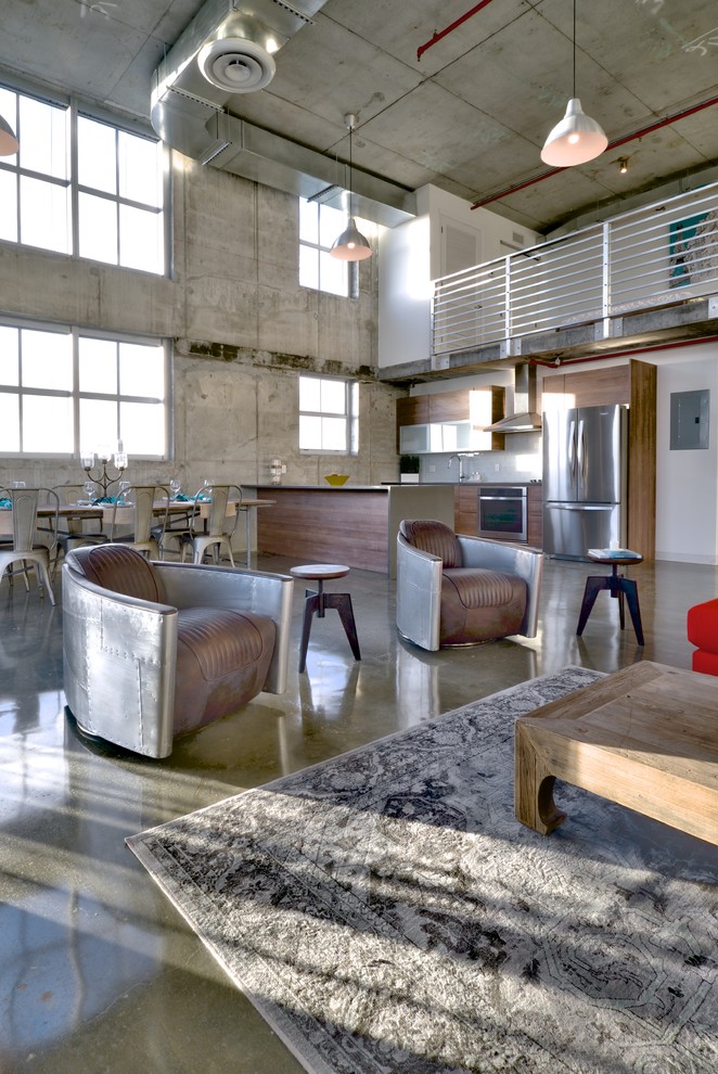 Large industrial living room in Miami with concrete floors.