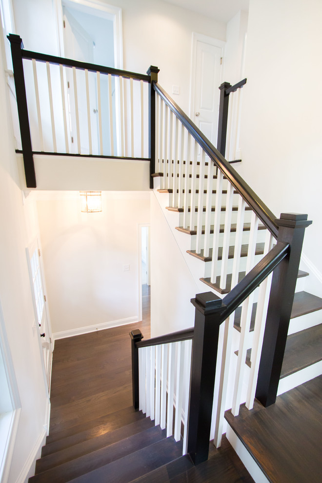 Inspiration for a mid-sized traditional wood u-shaped staircase in Philadelphia with painted wood risers.