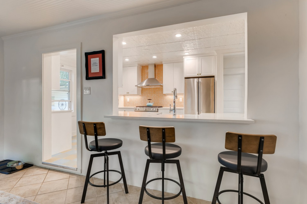 This is an example of a small galley separate kitchen in Denver with a farmhouse sink, shaker cabinets, white cabinets, quartz benchtops, orange splashback, mosaic tile splashback, stainless steel appliances, linoleum floors, no island, blue floor, white benchtop and recessed.