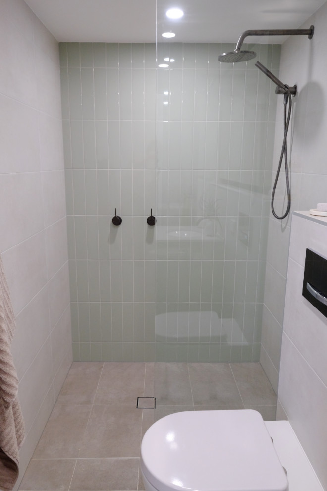 Example of a small urban porcelain tile and green tile porcelain tile, gray floor and single-sink bathroom design in Sydney with flat-panel cabinets, light wood cabinets, a wall-mount toilet, white walls, a drop-in sink, quartzite countertops, white countertops and a floating vanity