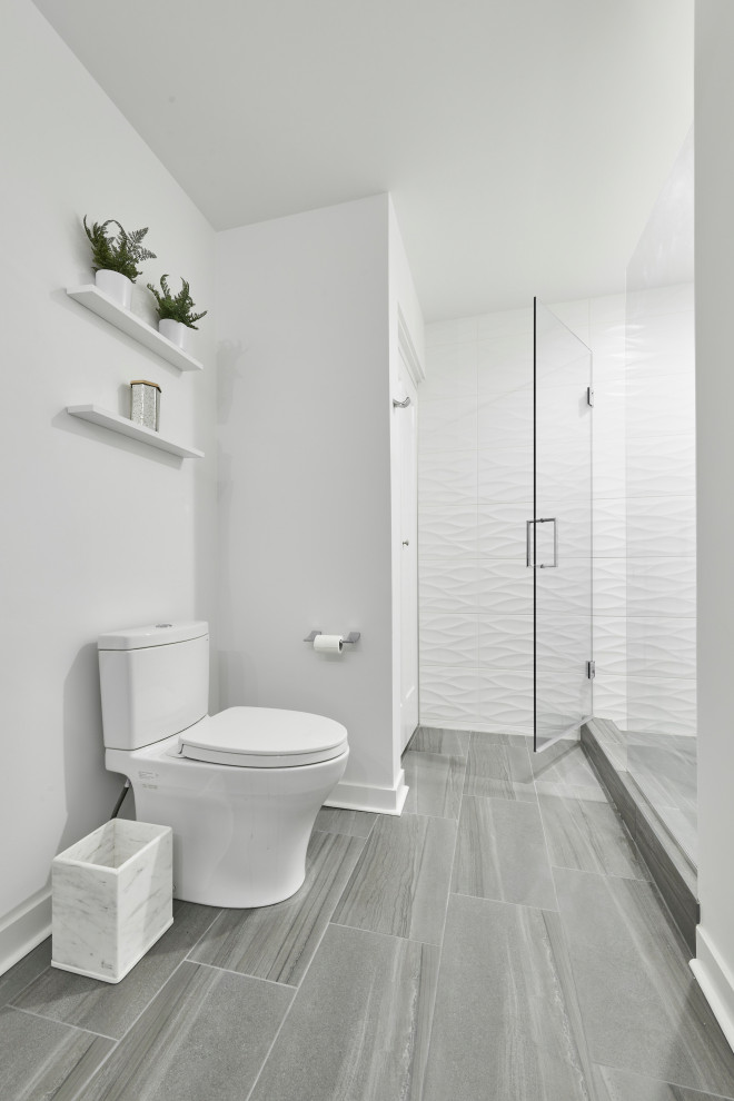 На фото: большая ванная комната в современном стиле с плоскими фасадами, белыми фасадами, душем в нише, унитазом-моноблоком, белой плиткой, керамогранитной плиткой, белыми стенами, полом из керамогранита, душевой кабиной, монолитной раковиной, столешницей из кварцита, серым полом, душем с распашными дверями, белой столешницей, нишей, тумбой под две раковины и подвесной тумбой с