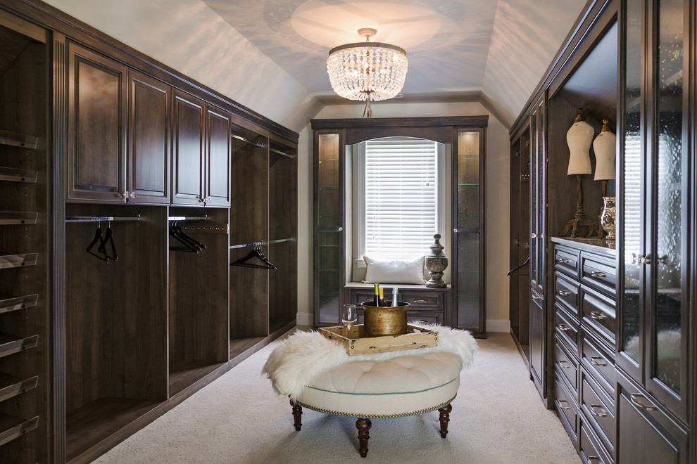 This is an example of a large transitional gender-neutral dressing room in Richmond with medium wood cabinets and carpet.