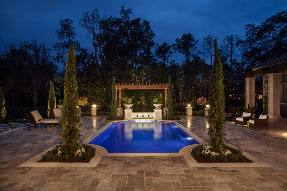 Mediterranean custom-shaped pool in Miami with a water feature.