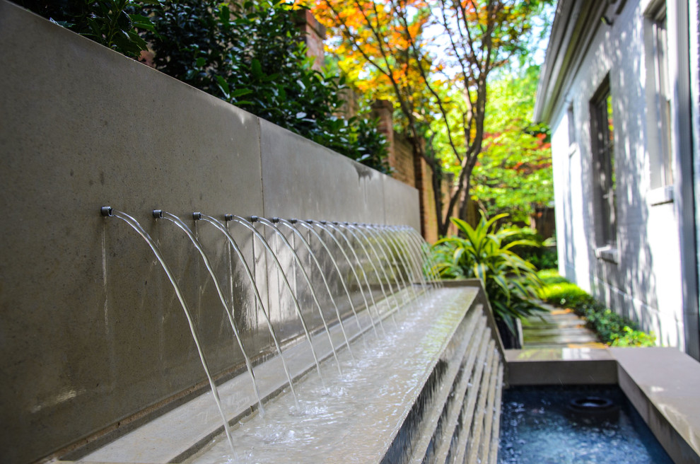 Inspiration for a small transitional side yard patio in Dallas with a water feature, decking and no cover.