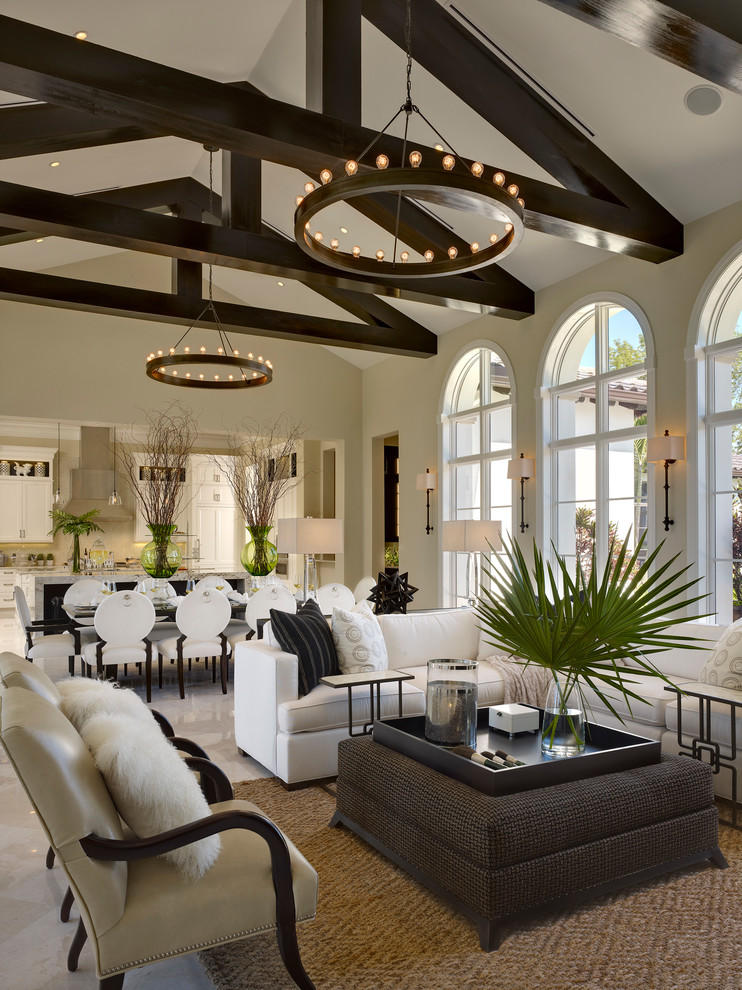 This is an example of a mediterranean open concept living room in Miami with beige walls.