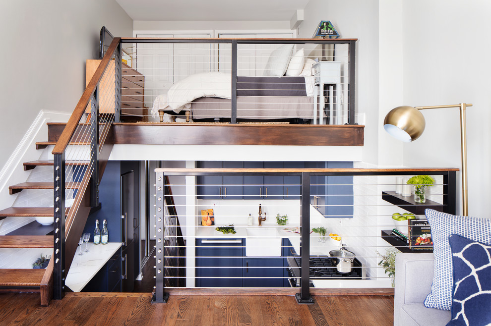 Inspiration for a small transitional dark wood floor and brown floor kitchen remodel in New York with a farmhouse sink, blue cabinets, white backsplash, ceramic backsplash, colored appliances and no island