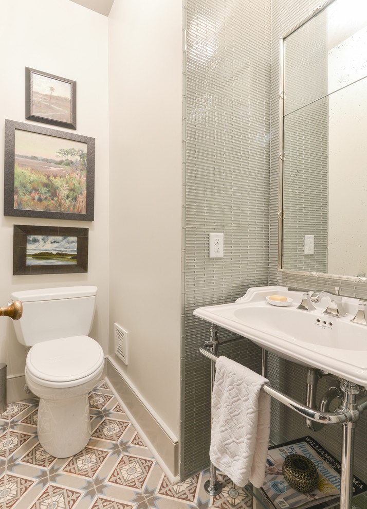 Traditional powder room in Charleston with a two-piece toilet, gray tile, white walls and a console sink.