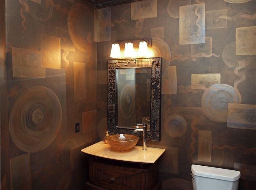 This is an example of an eclectic powder room in Cleveland with a vessel sink, furniture-like cabinets, dark wood cabinets and a one-piece toilet.