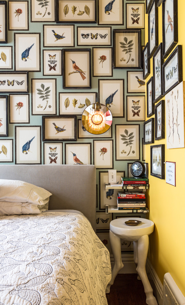 Inspiration for a mid-sized eclectic master bedroom in San Francisco with yellow walls and medium hardwood floors.