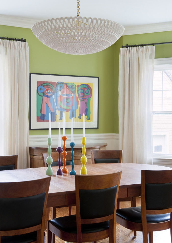Inspiration for an eclectic dining room in Boston with green walls and medium hardwood floors.