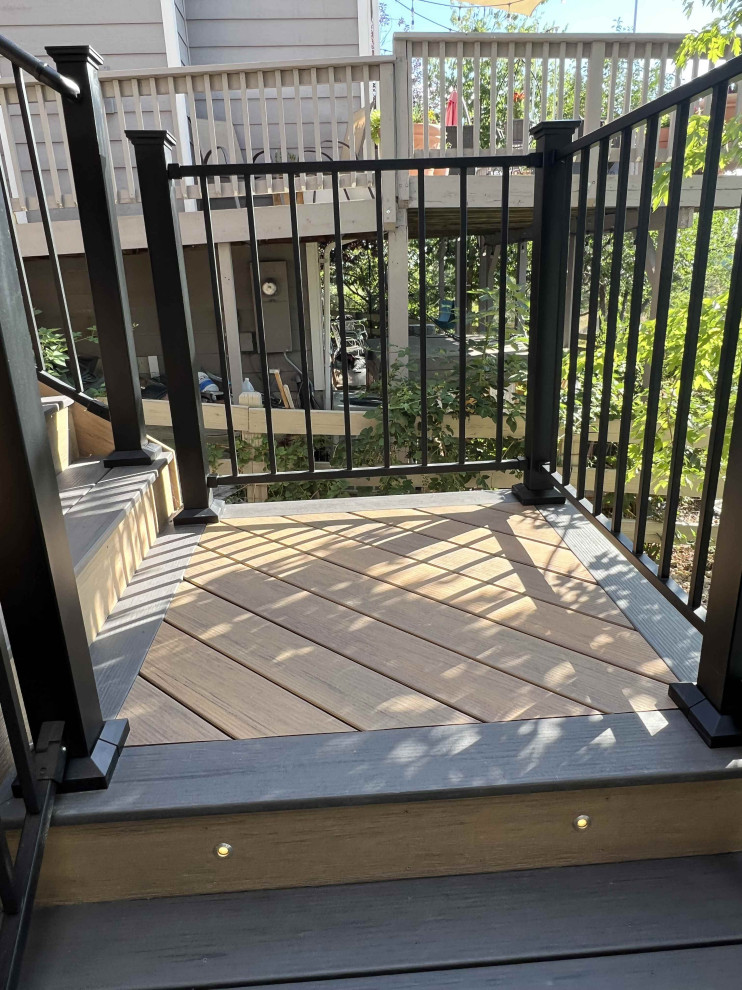 Deck skirting - mid-sized contemporary backyard second story metal railing deck skirting idea in Denver with a pergola