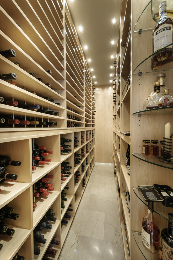 This is an example of a large contemporary wine cellar in Perth with storage racks.