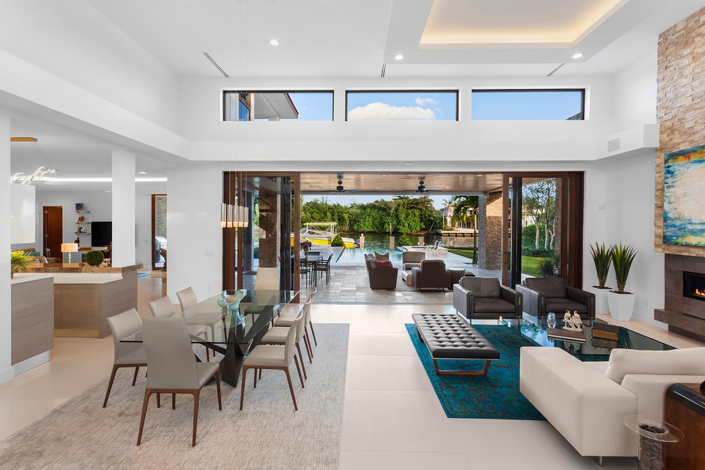 Inspiration for a large modern porcelain tile open concept kitchen remodel in Miami with a single-bowl sink, flat-panel cabinets, medium tone wood cabinets, quartz countertops, metallic backsplash, metal backsplash, paneled appliances, an island and white countertops