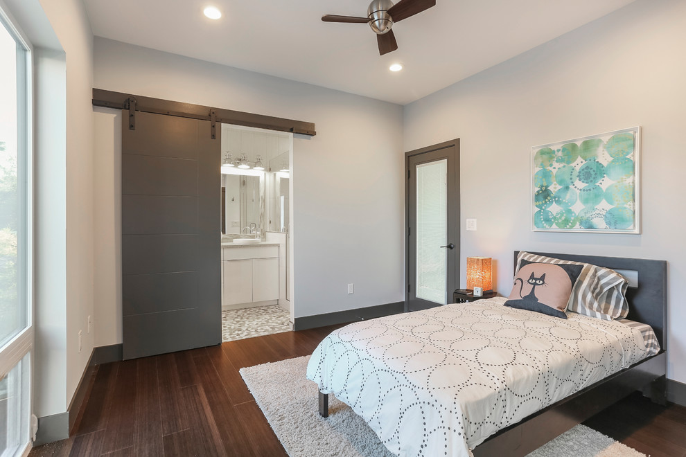 Photo of a mid-sized contemporary guest bedroom in Sacramento with white walls, dark hardwood floors, no fireplace and brown floor.