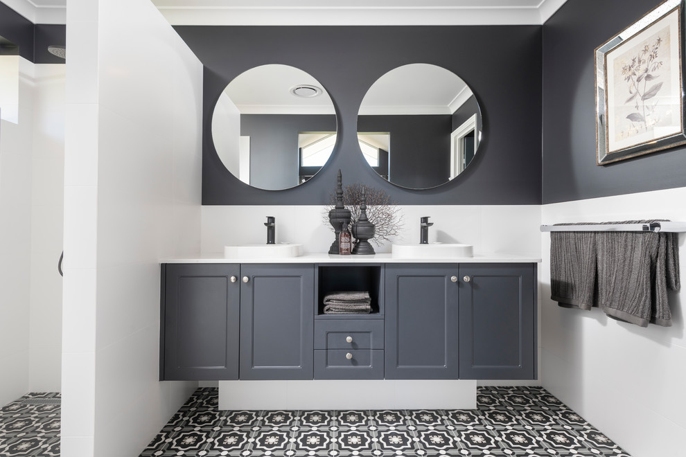 Inspiration for a wet room bathroom in Perth with recessed-panel cabinets, black cabinets, black walls, a vessel sink, multi-coloured floor, an open shower and white benchtops.