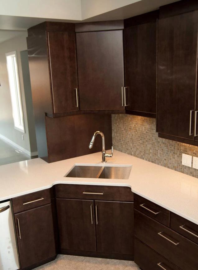 Inspiration for a mid-sized transitional l-shaped dark wood floor eat-in kitchen remodel with a double-bowl sink, shaker cabinets, dark wood cabinets, metallic backsplash, stainless steel appliances and a peninsula