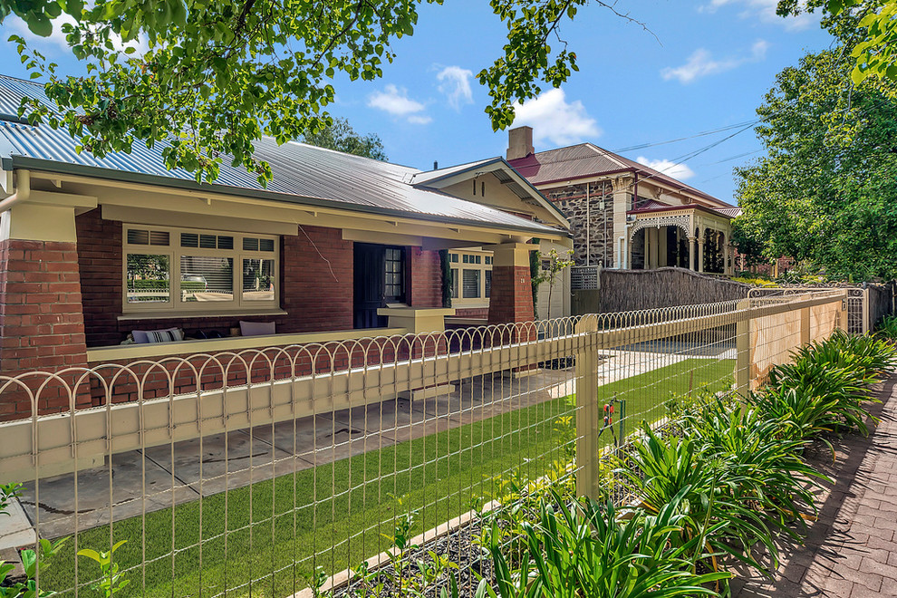 Traditional one-storey brick red house exterior in Adelaide with a metal roof.