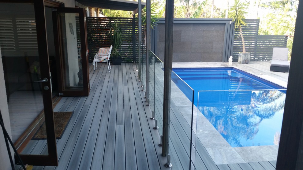 This is an example of a large contemporary backyard rectangular aboveground pool in Sydney with decking.