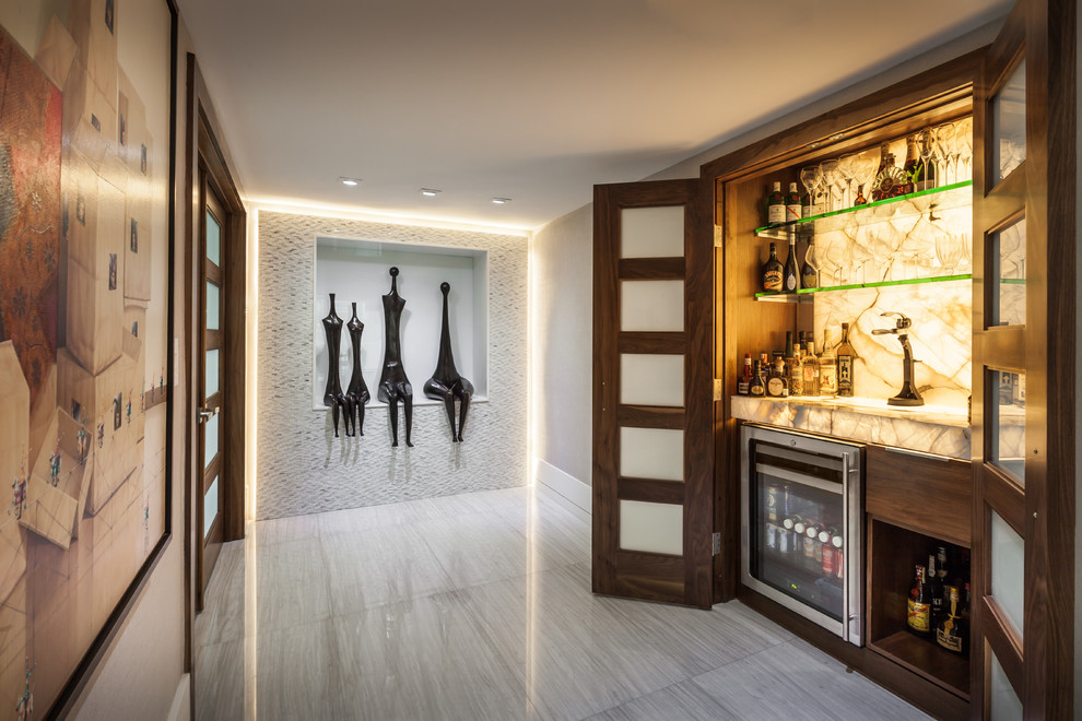 Design ideas for a small contemporary single-wall home bar in Miami with flat-panel cabinets, dark wood cabinets, white splashback and stone slab splashback.