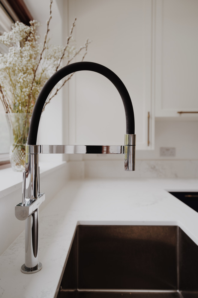 Design ideas for a medium sized classic u-shaped enclosed kitchen in London with shaker cabinets, blue cabinets, quartz worktops, no island and white worktops.