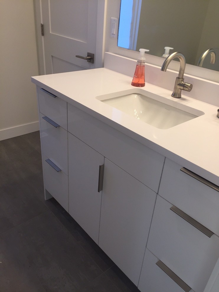 Mid-sized modern bathroom in Other with flat-panel cabinets, white cabinets, white tile, porcelain floors, an undermount sink and engineered quartz benchtops.