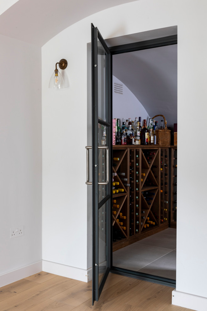 This is an example of a contemporary wine cellar in Surrey.