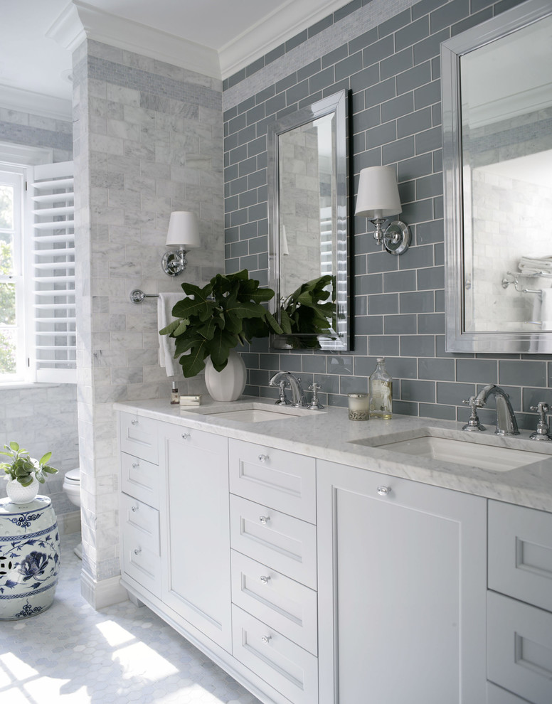 Inspiration for a traditional bathroom in Raleigh with an undermount sink, recessed-panel cabinets, white cabinets and gray tile.