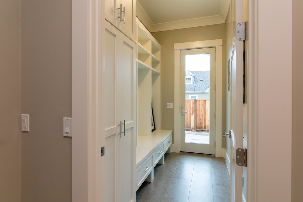 Design ideas for a contemporary mudroom in San Francisco with medium hardwood floors, a single front door and a medium wood front door.