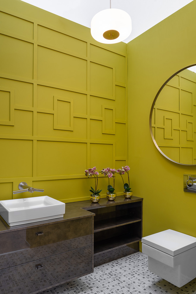 This is an example of a contemporary bathroom in Dublin with brown cabinets, a wall-mount toilet, green walls, mosaic tile floors, a vessel sink, grey floor and brown benchtops.